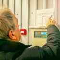 Worker Maintaining Commercial Fire Alarm System