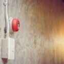 close up of fire alarm bell on wall in an industrial building